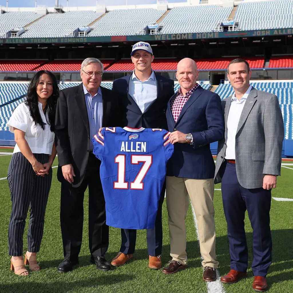 Josh Allen holding up his No. 17 gear with his family.