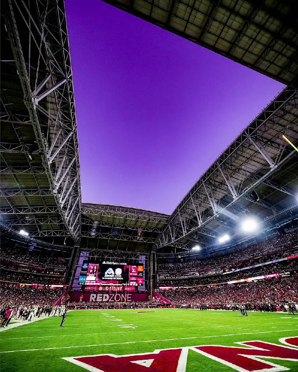 State Farm Stadium designed with roll-out natural grass surface and retractable roof.