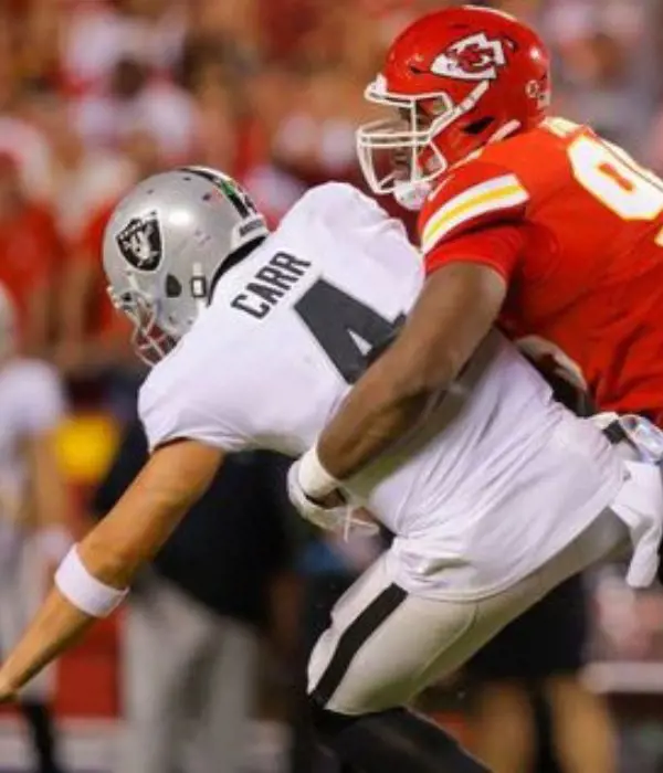 Quarterback being tackled by the defense in the game.