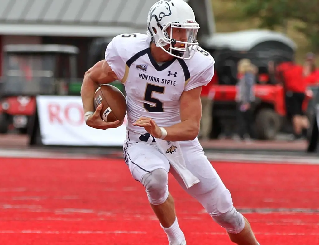 Quarterback Dakota playing football wearing his jersey 