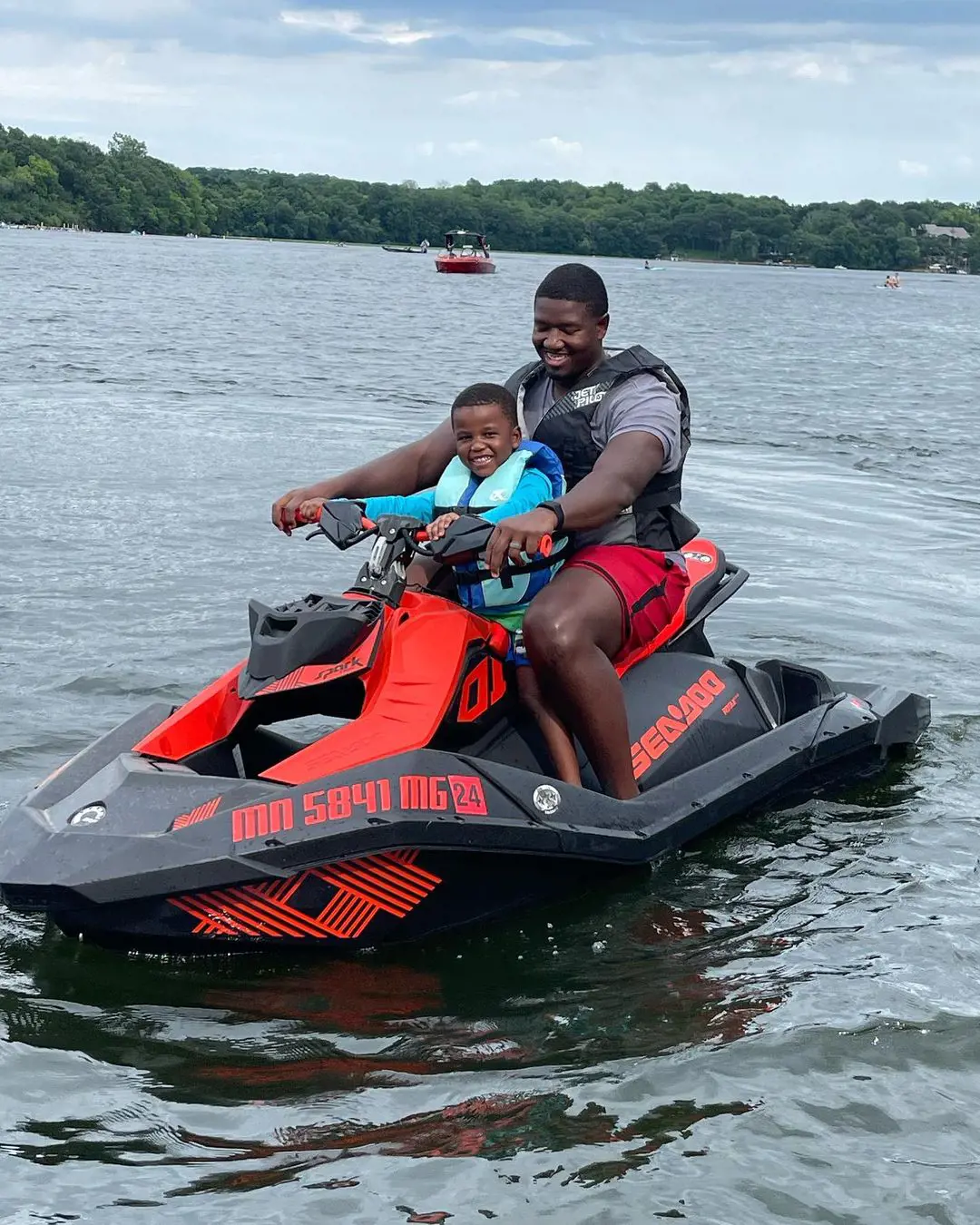 Kelvin III enjoying the motorboat ride with his dad.