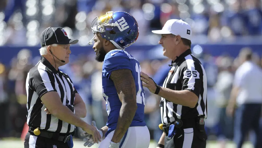 Football officials and referee mark the fouls in the game